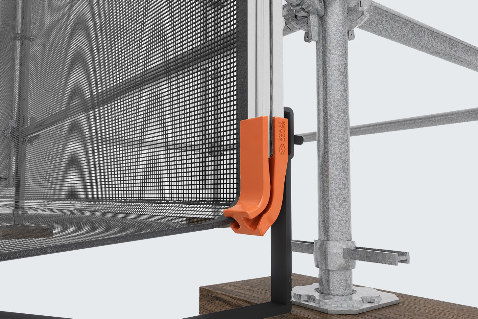 TRAKTEC track and guide holding a panel edge in place on an installed scaffold, with the orange guide clip visible